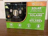 Full box front showing Sunforce brand, product name, LED bulb count, cable length, and main features including remote control and solar powering.