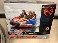 Front of original box showing three riders on Striker3 tube and branding