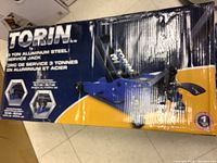 Photo of front of box showing brand Torin and 3 ton aluminum steel service jack labeling with product image.