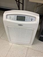 Front view of the white Whirlpool Whispure air cleaner showing the intake grille and Whirlpool logo.