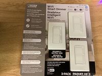 Front view of the boxed Feit Electric Wi-Fi Smart Dimmer 3-pack showing switch image and key features
