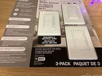 Front packaging showing three smart dimmer switches with wall plates installed, clear protective plastic with product branding and features visible.