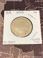 Front side of the 1919 Newfoundland 50 cents silver coin showing denomination and year.
