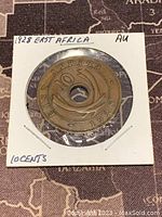 Front side of 1928 East Africa 10 cents coin showing 'EAST AFRICA 10 1928' around center hole