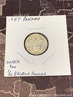 Front side of the 1947 Panama 1/10 Balboa silver coin showing the Panama coat of arms and handwritten note indicating silver 0.900 purity.