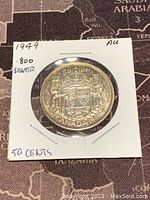 Reverse side of the 1949 Canadian 50 cent coin featuring the Canadian coat of arms and denomination.