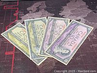 Four Canadian 1954 banknotes, two $10 and two $20, laid out flat showing front design