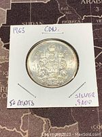 Reverse side of 1963 Canadian 50 cents silver coin featuring Canadian coat of arms, date, and silver content marking.