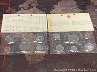 Two sealed Canadian proof-like coin sets from 1976 and 1977 with informational inserts visible.