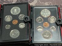 Both 1977 and 1978 Canadian proof coin sets displayed open in cases showing all coins