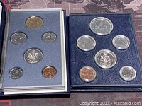 Photo showing two Canadian specimen coin sets displayed side by side in cases, one from 1981 and one from 1991, each with seven coins.