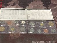 Photo showing two Canadian proof-like coin sets from 2001 and 2002, each set sealed in plastic with accompanying specification cards.