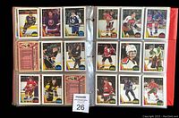 Photo of two binder pages with 18 hockey cards from 1987-88 O.P.C. set, featuring players from Kings, Islanders, Leafs, Black Hawks, Flyers, Rangers, Flames, Penguins, Capitals, Devils