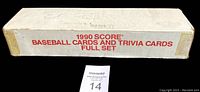 Side view of the sealed white box with red Score branding and full set description.