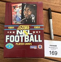 Front of sealed 1991 Score NFL Football Player Cards Series 1 wax box with factory tape and football player images.