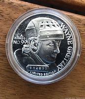 Close-up image of the silver medallion front showing Wayne Gretzky's profile, 'L.A.KINGS NO 99', limited edition number 018577, and his name.