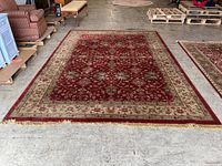 Full view of rug laid flat on concrete floor in warehouse