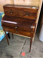 Full view of the wood secretary desk with roll-top and slim legs