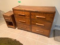 Wooden dresser and matching side table set shown front view.