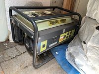 Side view showing tubular steel frame, fuel tank, Champion branding and front AC outlets