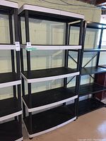 Front view of Keter shelving unit showing all four shelves and plastic frame.