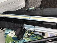 Two LED light bars laying on a fabric surface with power cords and mounting hardware visible.