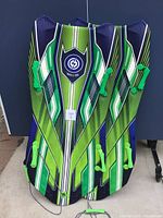 Pair of Sno-Storm VIPEREX snow sleds side by side, showing vibrant green and blue striped patterns and green handles.