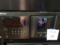 Close-up photo of the front panel of Sony Mega Storage 300CD CD player showing the power and control buttons, display screen, and Mega Storage labeled compartment.