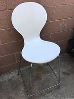 Photo showing the entire white vintage tall chair with a rounded seat and backrest, chrome legs, and no visible rust or damage.
