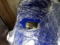 Close-up of Yamaha badge on blue drum shell wrapped in plastic
