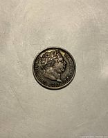 Obverse side of 1817 Bullhead UK coin showing King George III's profile with laurel wreath and inscriptions including the date 1817.