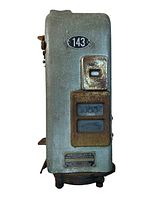 Side front view of antique Johnson fare box showing metal body, number plate 143, rusted fare display, coin slot cover, and patent plaque.
