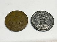 Front side of two tokens; left token with ship and 'FREEDOM DISCUSSION,' right token with Liberty Bell and dates 1776-1876.