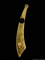 Photo shows full length of the curved letter opener with visible engraving and raised decoration on black background. The size comparison to a baseball is noted but baseball not included.