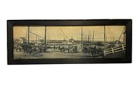 Full view of the framed black and white panoramic antique photo of the harbor block with boats, horse carriages, and people.