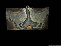 Close-up of vintage hen-shaped letterpress stamp showing metal design and wooden block.