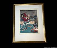 Framed Japanese print showing a full view of the print in a gold-tone frame with matting, depicting a traditional Japanese scene.