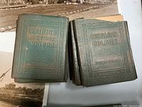 Two stacks of small hardcover books, one titled 'Vampire and Other Verses' by Rudyard Kipling and the other 'Sherlock Holmes' by Conan Doyle