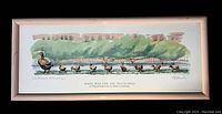 Full view of framed art print titled 'Make Way For The Ducklings' showing ducks walking by a pond or river with trees and a fence background.