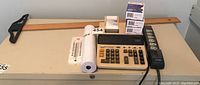Full view of the lot on a table showing the calculator, paper rolls, T-square, thermostat, and power bar.