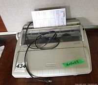 Full view of beige Brother GX-6750 Correctronic electric typewriter showing its overall condition and power cord with plug in front.