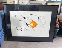 Framed indigenous art print titled "Migration" featuring stylized birds flying with a sun in the background. The frame is black and matted in white, with some spots on glass and needs cleaning.