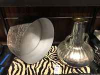 The large metal bowl and mercury glass vase side by side.
