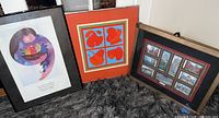 Three framed prints arranged on floor showing full lot