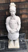 Front view of the plaster garden statue depicting an Asian warrior in traditional armor and headgear.