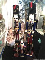 Front view of all four nutcrackers showing heights and various outfits