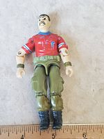 Full view of GI Joe figure showing red shirt, green pants, black boots, and articulation points.