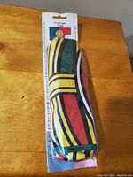 Photo showing the folded Portugal flag inside clear plastic packaging with cardboard header containing the Portugal flag image and text.