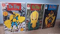 Three Dr. Fate comic books standing upright with covers visible showing issues #1, #2, and #4.
