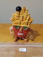 Front view of Fat Frenchy French Fry Food Fighter figurine showing character details and condition.